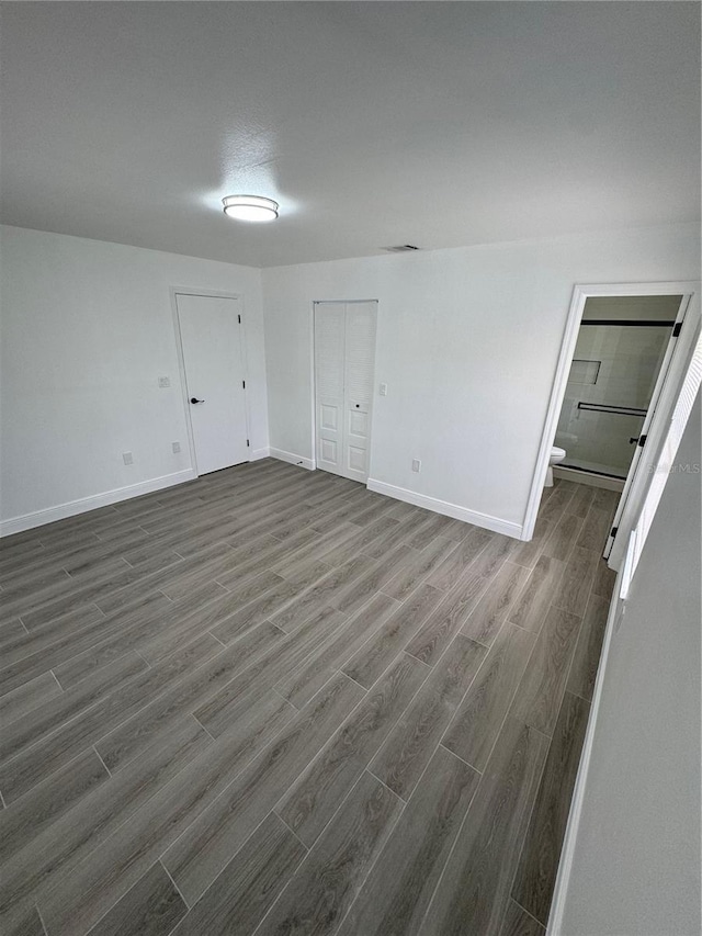 spare room featuring dark wood-type flooring