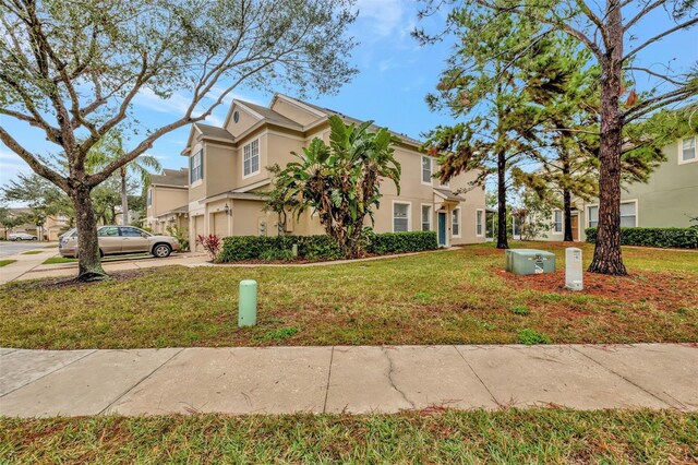 view of front of home featuring a garage and a front lawn