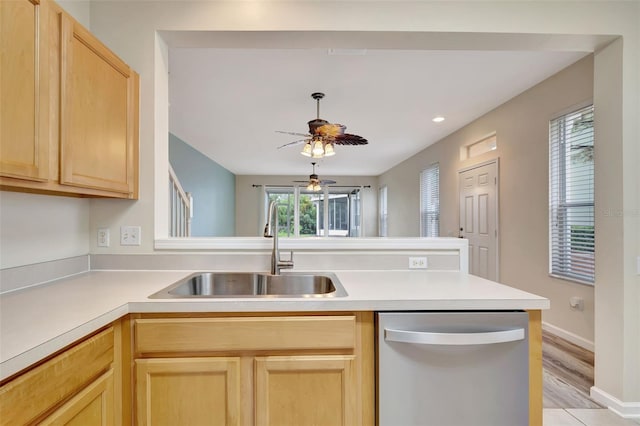 kitchen featuring dishwasher, light brown cabinets, sink, kitchen peninsula, and light hardwood / wood-style flooring