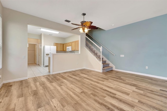 unfurnished living room with light hardwood / wood-style floors and ceiling fan