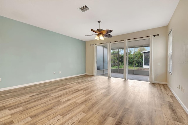 empty room with light wood-type flooring and ceiling fan