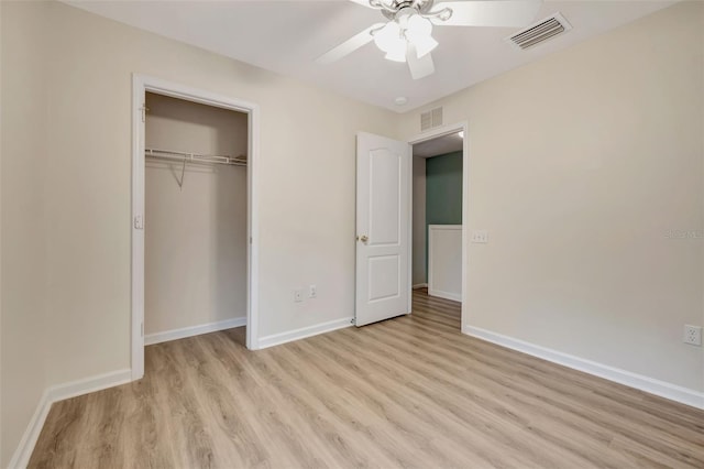 unfurnished bedroom with a closet, ceiling fan, and light wood-type flooring