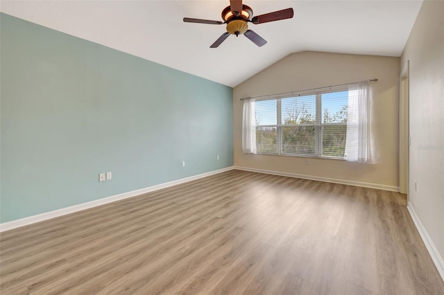 empty room with light wood-type flooring, vaulted ceiling, and ceiling fan