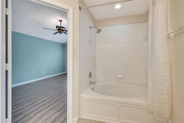 bathroom with wood-type flooring, shower / bath combo with shower curtain, and ceiling fan