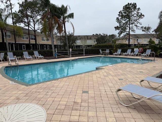 view of swimming pool featuring a patio area