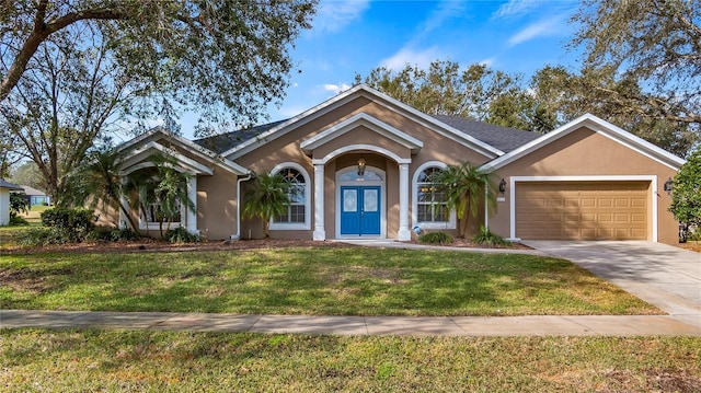 single story home featuring french doors, a garage, and a front lawn