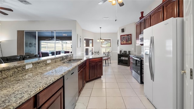 kitchen featuring light tile patterned flooring, appliances with stainless steel finishes, sink, and ceiling fan with notable chandelier