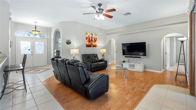 living room with light tile patterned flooring and ceiling fan