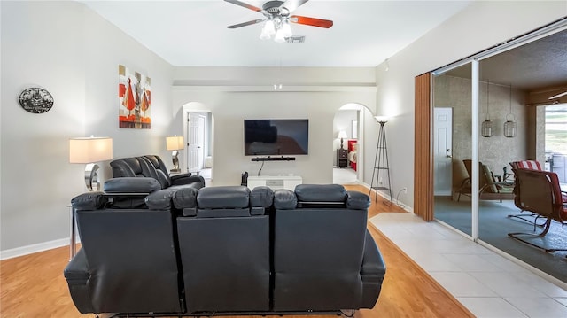 living room featuring ceiling fan and light wood-type flooring