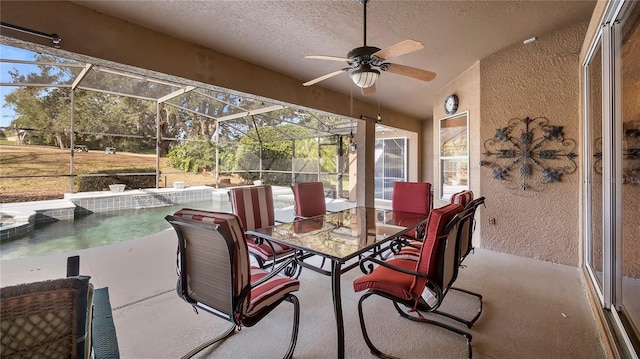 view of patio / terrace with ceiling fan and glass enclosure