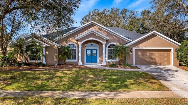 ranch-style home with a garage, french doors, and a front lawn