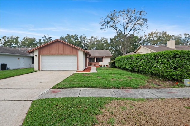 single story home featuring a front lawn and a garage