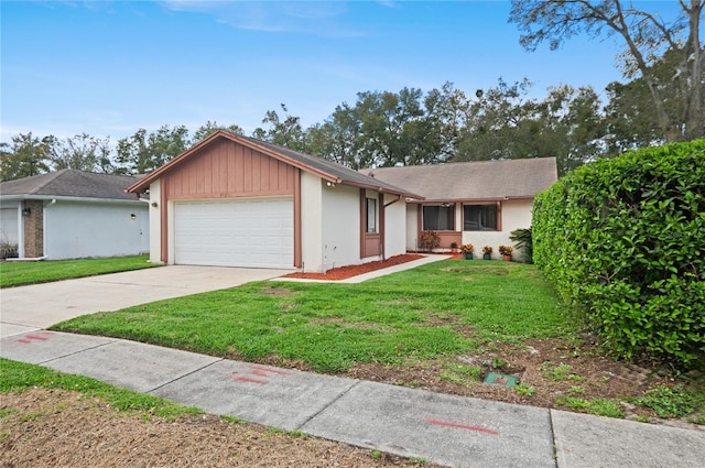 single story home featuring a front lawn and a garage