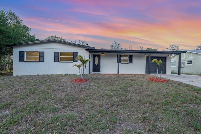 single story home featuring a carport and a yard