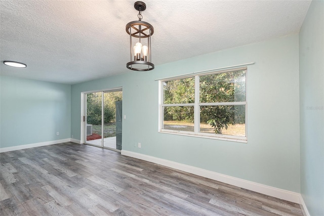 empty room featuring hardwood / wood-style floors and a textured ceiling