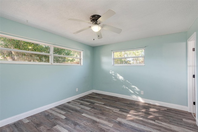 empty room with ceiling fan, dark hardwood / wood-style floors, and a textured ceiling