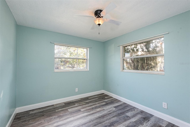 unfurnished room featuring dark hardwood / wood-style flooring, ceiling fan, and a textured ceiling