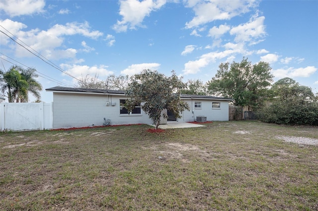 back of property featuring a patio, central AC, and a lawn