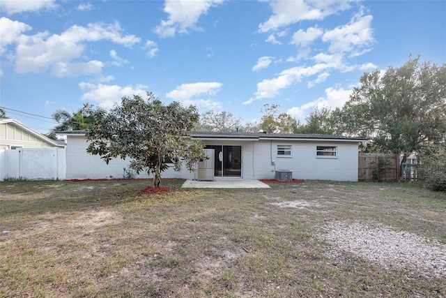 rear view of property featuring a yard and a patio area