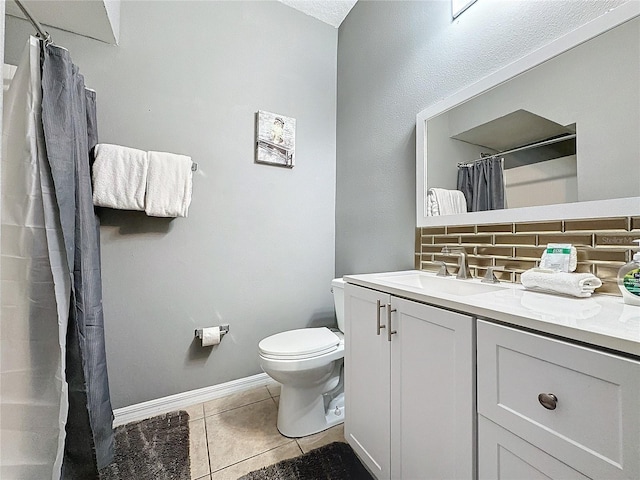 bathroom with tile patterned floors, toilet, vanity, and backsplash