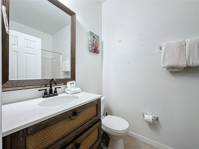 bathroom with walk in shower, tile patterned floors, vanity, and toilet