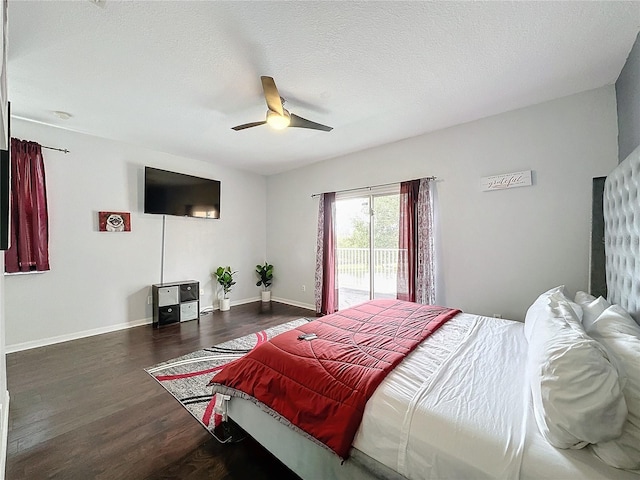 bedroom featuring dark hardwood / wood-style flooring, access to outside, a textured ceiling, and ceiling fan