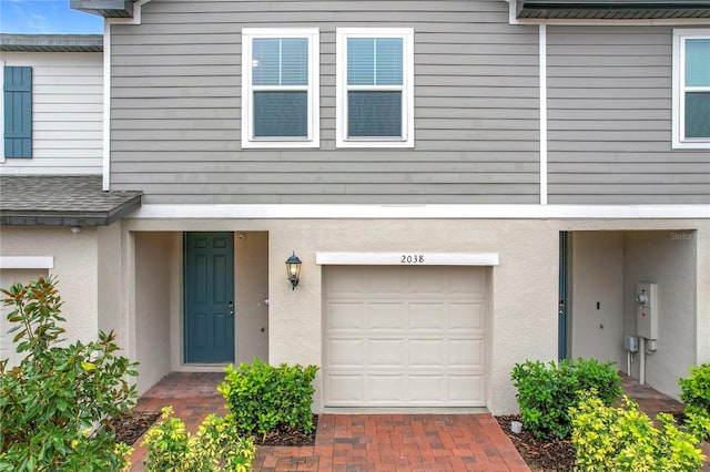 doorway to property with a garage