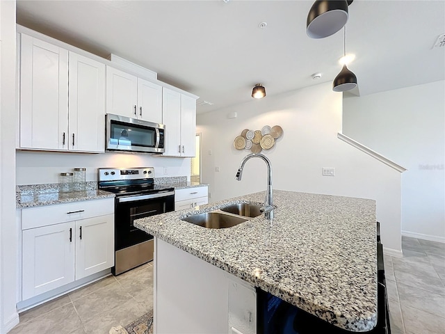 kitchen featuring sink, an island with sink, white cabinets, and stainless steel appliances