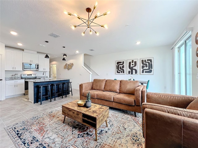 living room featuring sink, an inviting chandelier, and light tile patterned flooring