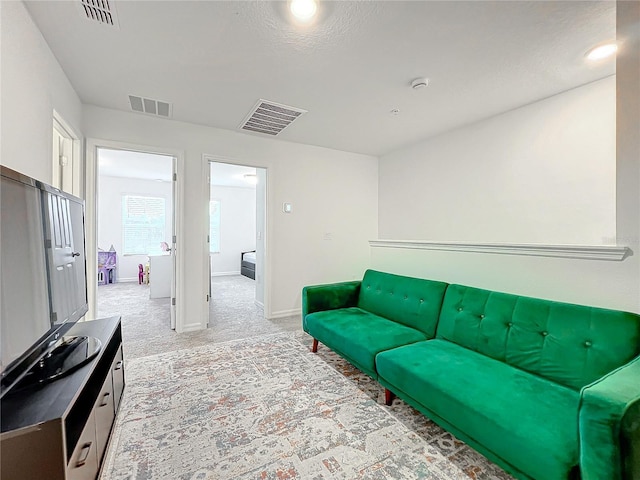 living room with light carpet and a textured ceiling