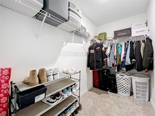 walk in closet with carpet floors