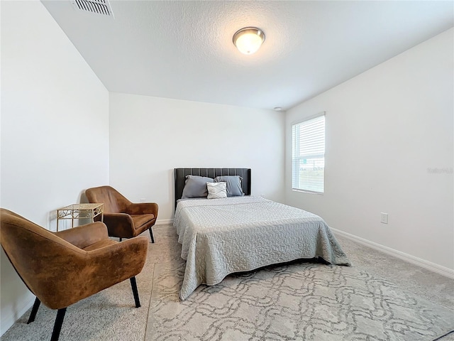 carpeted bedroom featuring a textured ceiling