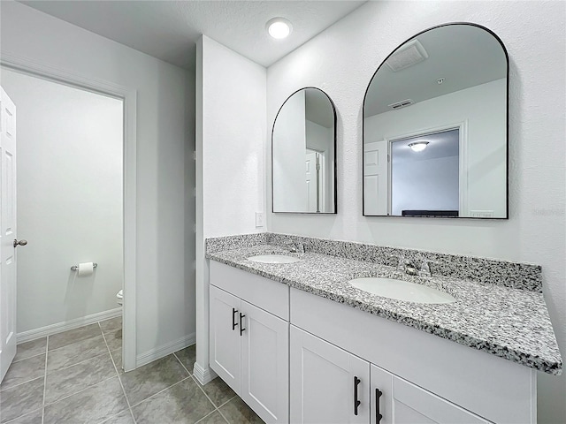 bathroom with tile patterned floors, toilet, and vanity