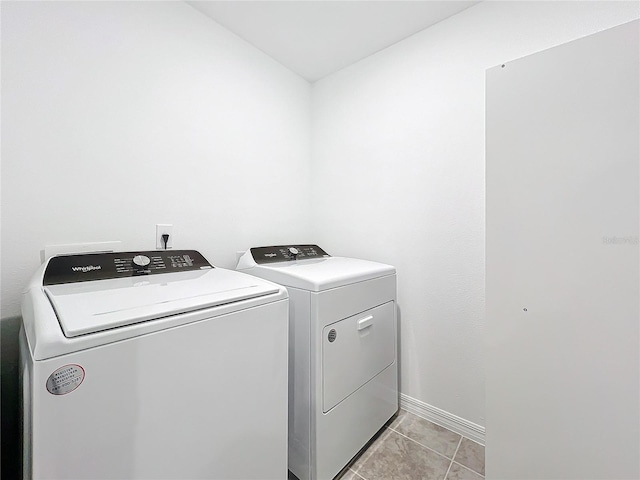 washroom with separate washer and dryer and light tile patterned flooring