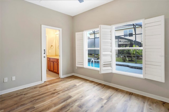 empty room featuring light wood-type flooring and ceiling fan