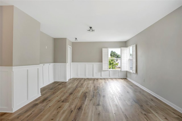 empty room with light hardwood / wood-style flooring