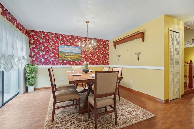 dining space with wallpapered walls, baseboards, a notable chandelier, and tile patterned floors