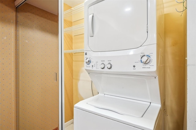 laundry area featuring laundry area and stacked washer / drying machine