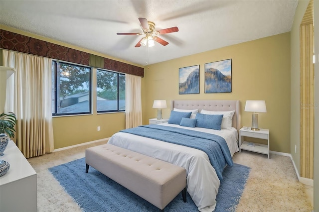 bedroom with ceiling fan and baseboards