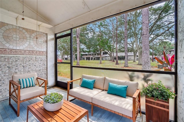 sunroom featuring lofted ceiling