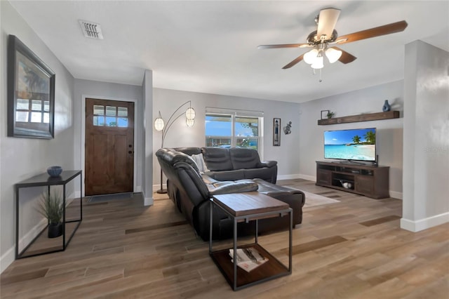 living room featuring hardwood / wood-style flooring and ceiling fan