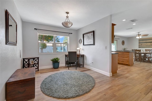 interior space with ceiling fan and light hardwood / wood-style floors