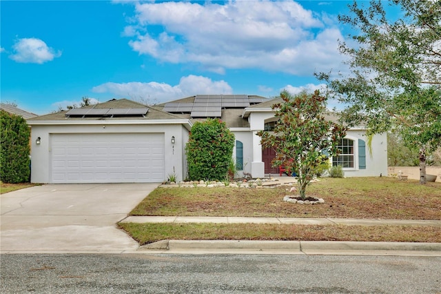 view of front of home featuring a garage and solar panels