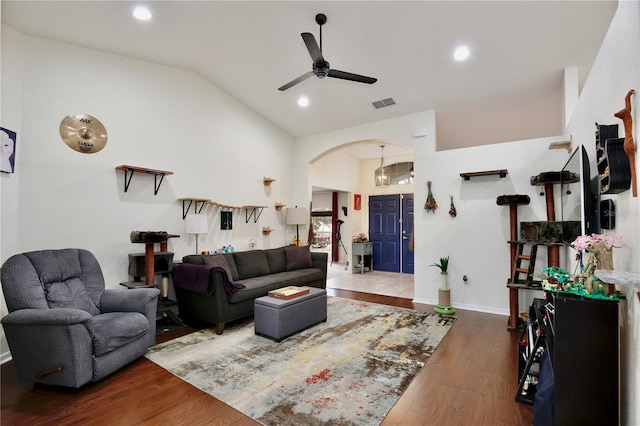 living room featuring ceiling fan, lofted ceiling, and dark hardwood / wood-style flooring