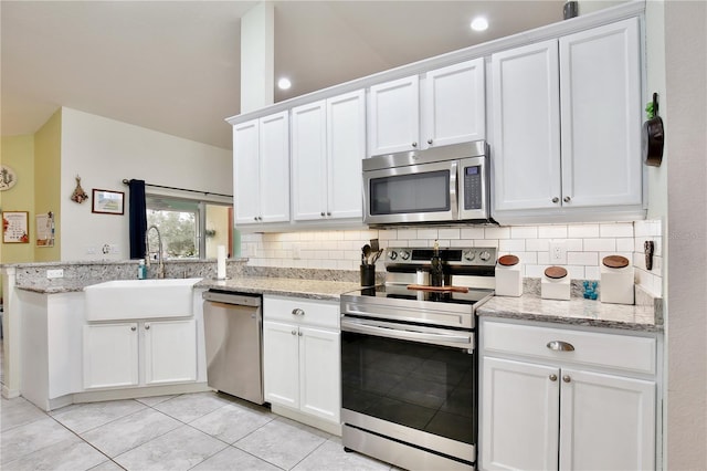 kitchen featuring tasteful backsplash, white cabinets, and appliances with stainless steel finishes