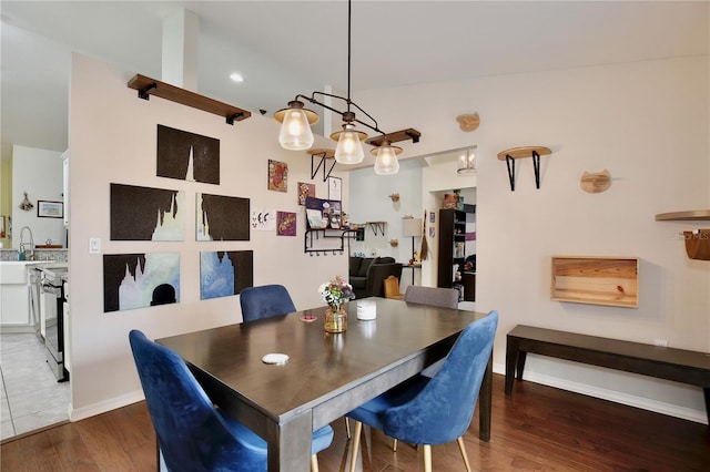 dining space with dark hardwood / wood-style flooring and sink