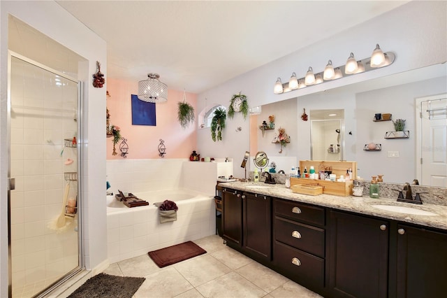 bathroom with tile patterned floors, separate shower and tub, and vanity