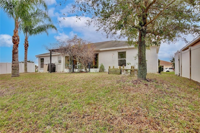 rear view of house with a lawn