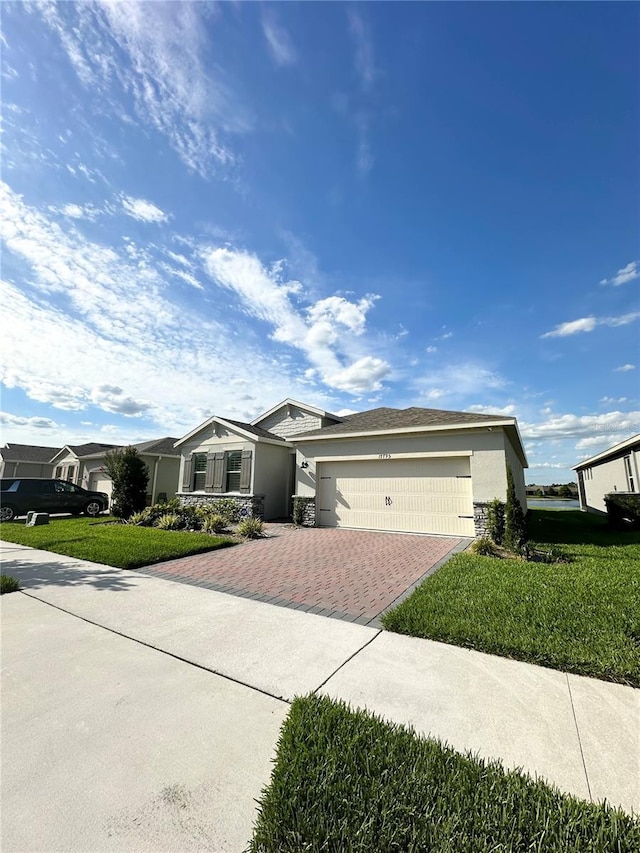 single story home featuring a garage and a front lawn