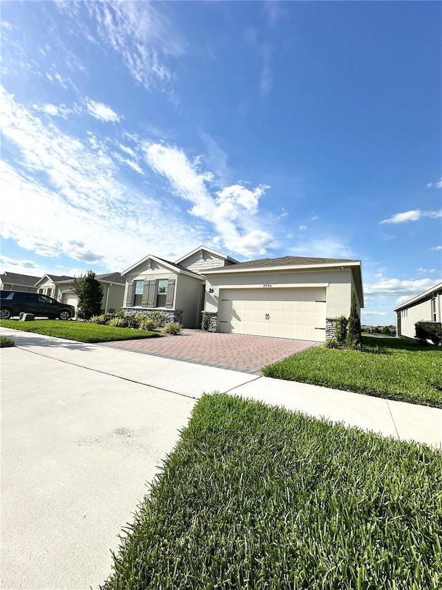 ranch-style home featuring a garage and a front yard